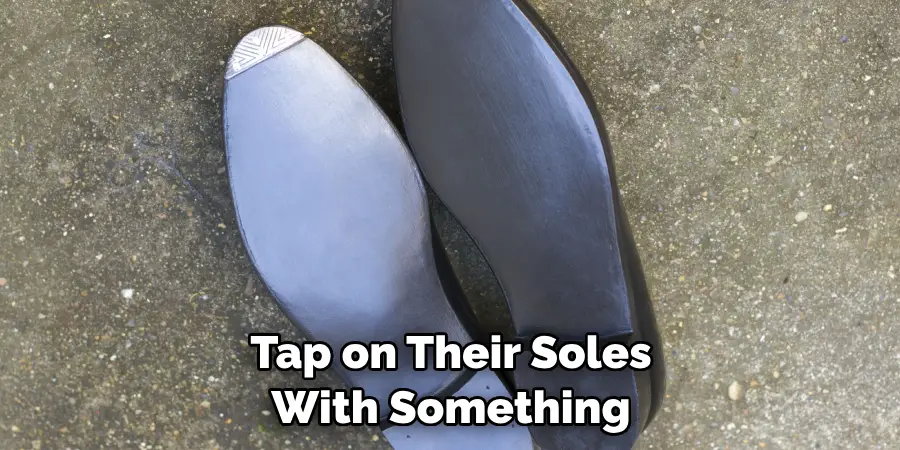 Tap on Their Soles With Something