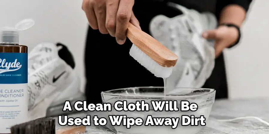 Dip the brush into the cleaning solution shoe